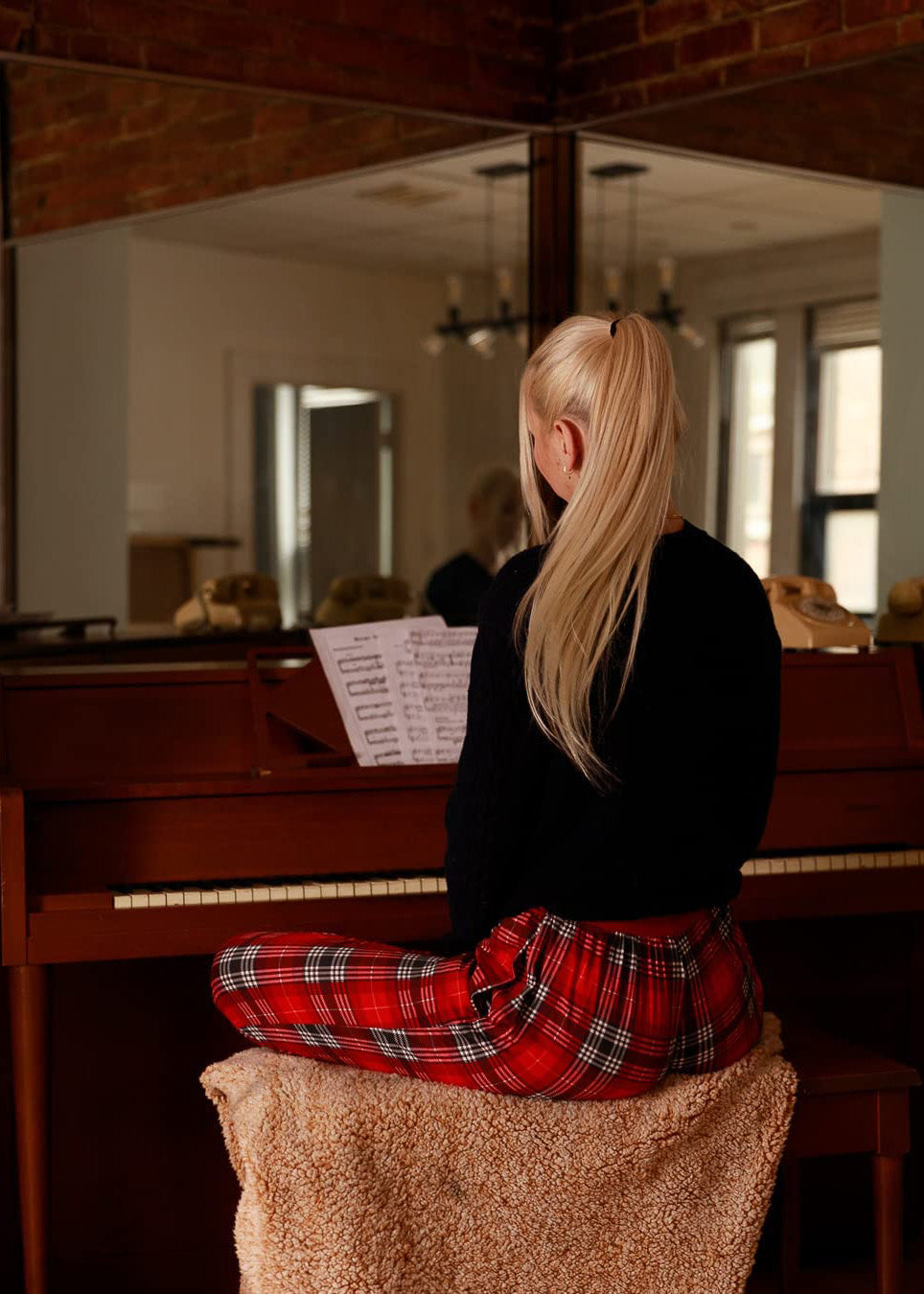 PJ joggers with soft velvety texture, stretch, elastic waistband, drawstring, and stylish ankle cuff. This pattern a red tartan, wish white and black lines.
