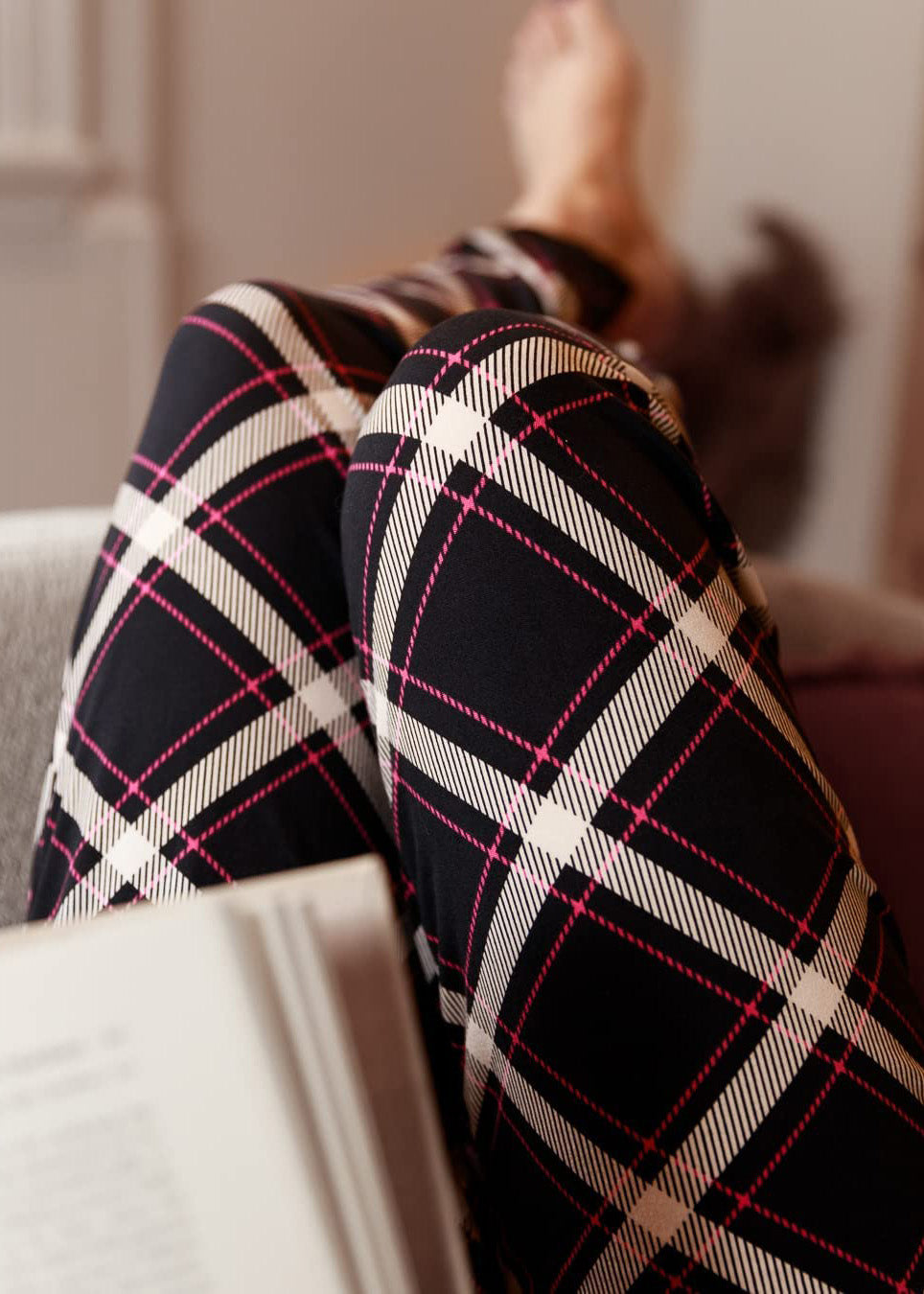 PJ joggers with soft velvety texture, stretch, elastic waistband, drawstring, and stylish ankle cuff. This pattern is a navy plaid with white and red lines. it also features a red drawstring.