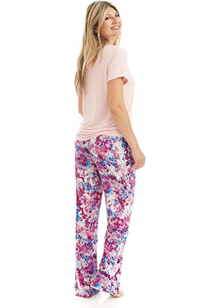 
                  
                    T Shirt and Pant Pajama set. The t-shirt is solid light pink. it has a pocket and a neck trim that matches the pattern on the pants. the pattern on the pants is a pink, white and blue flower pattern.
                  
                