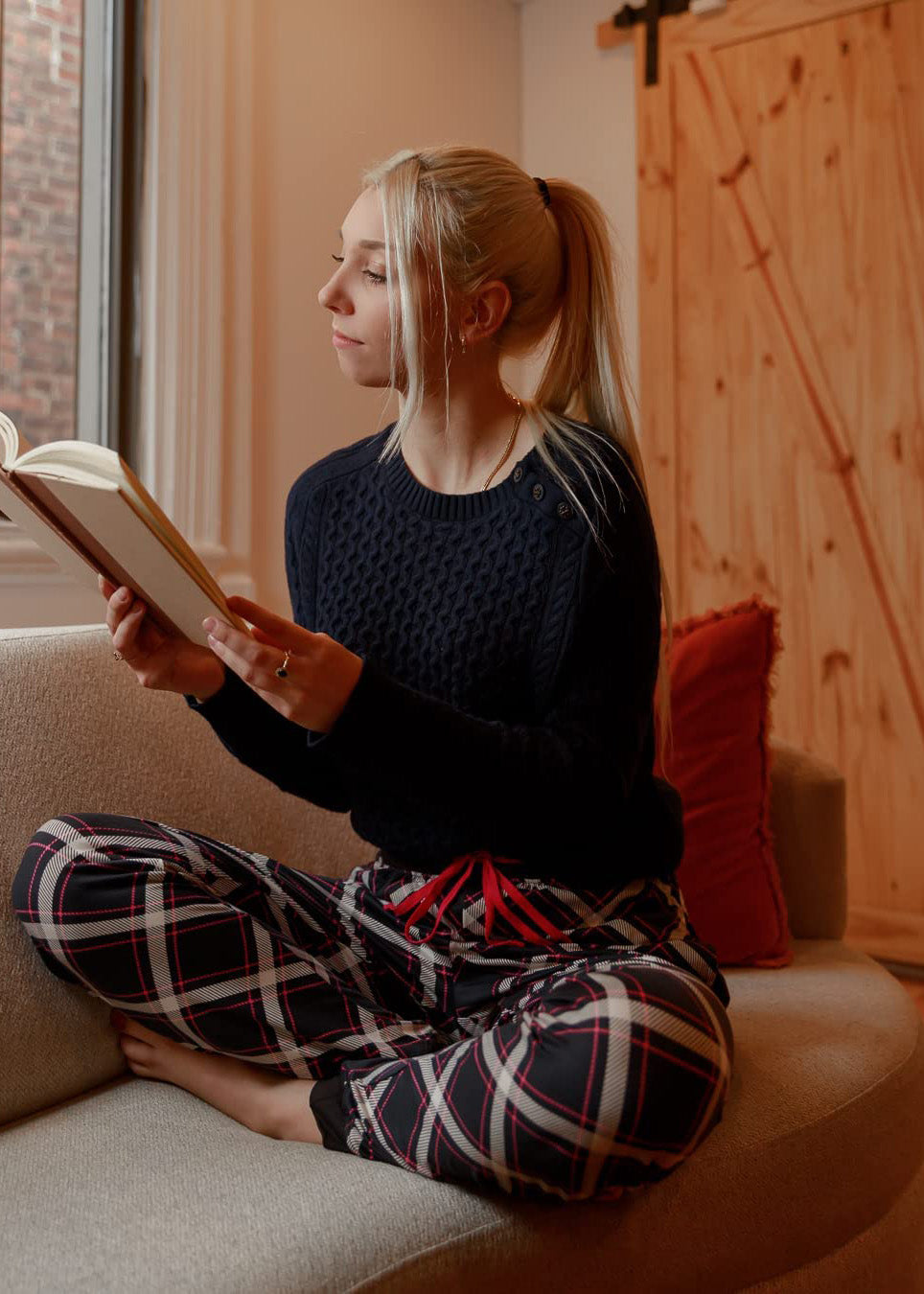 PJ joggers with soft velvety texture, stretch, elastic waistband, drawstring, and stylish ankle cuff. This pattern is a navy plaid with white and red lines.  it also features a red drawstring
