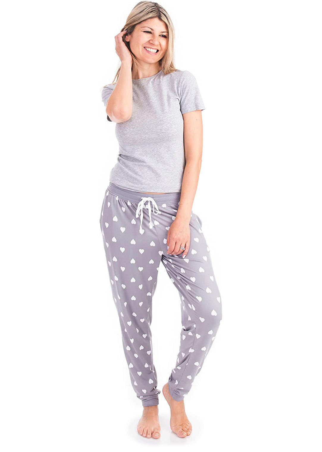 PJ joggers with soft velvety texture, stretch, elastic waistband, drawstring, and stylish ankle cuff. This pattern is white hearts on a grey background. The cuffs and the waist are matching grey.