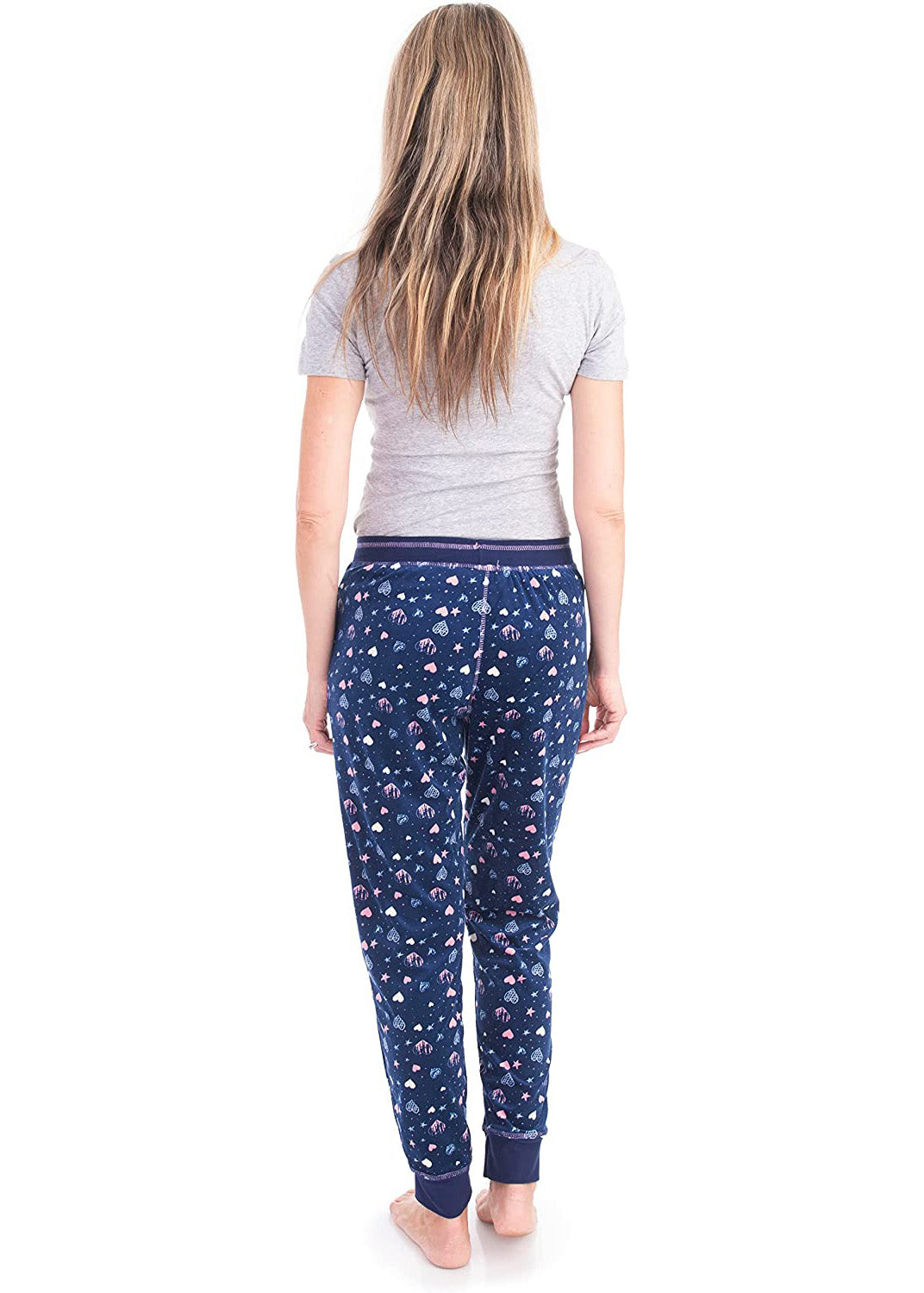
                  
                    PJ joggers with soft velvety texture, stretch, elastic waistband, drawstring, and stylish ankle cuff. This pattern is a light blue, light pink hearts and starts on a navy background. It features a pink drawstring.
                  
                