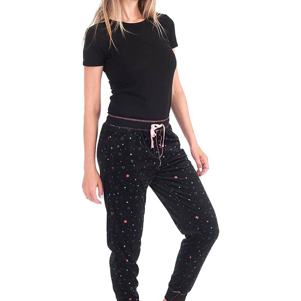 
                  
                    PJ joggers with soft velvety texture, stretch, elastic waistband, drawstring, and stylish ankle cuff. This pattern is scattered stars, very small pink, blue, yellow stars on a black background. The product has a pink overstitch.
                  
                