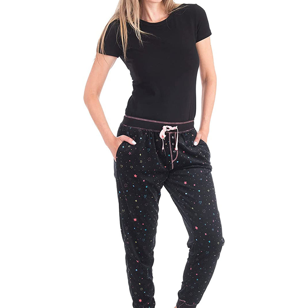 
                  
                    PJ joggers with soft velvety texture, stretch, elastic waistband, drawstring, and stylish ankle cuff. This pattern is scattered stars, very small pink, blue, yellow stars on a black background. The product has a pink overstitch.
                  
                