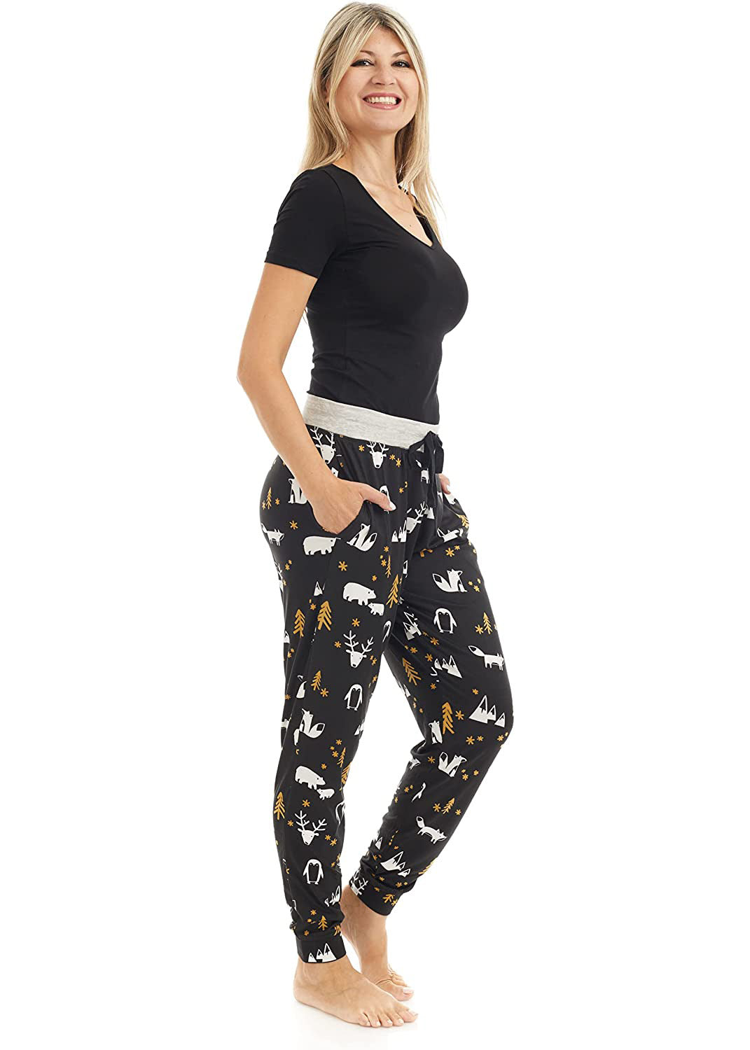 
                  
                    PJ joggers with soft velvety texture, stretch, elastic waistband, drawstring, and stylish ankle cuff. This pattern is little woodland creatures, like a foxm deer, penguin, and some mountains, trees. The pattern is gold and white on a black background. The waist is light grey with a black drawstring.
                  
                