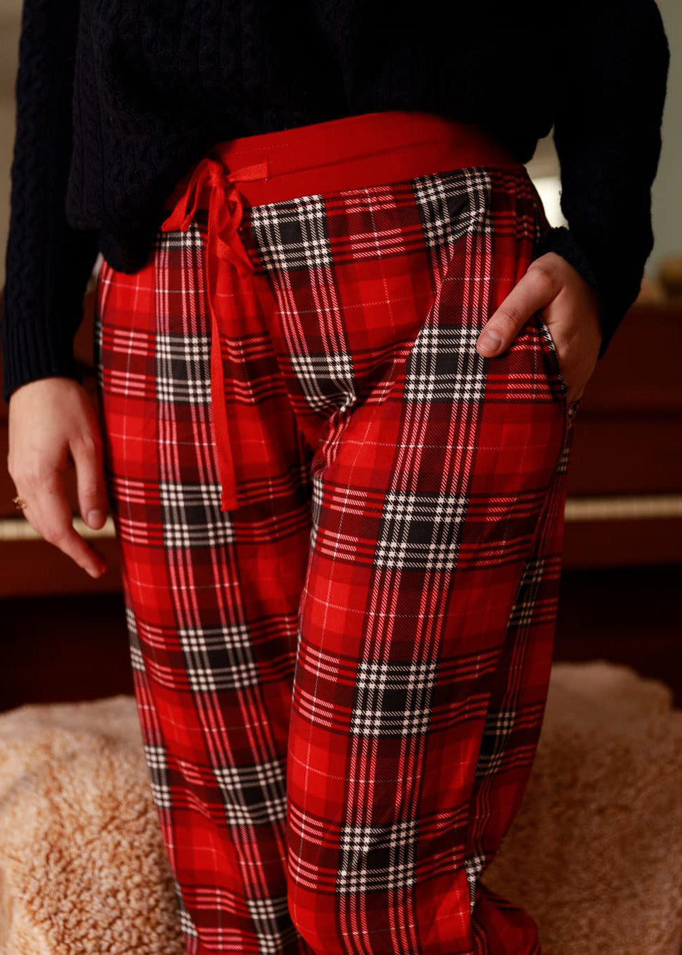 PJ joggers with soft velvety texture, stretch, elastic waistband, drawstring, and stylish ankle cuff. This pattern a red tartan, wish white and black lines.