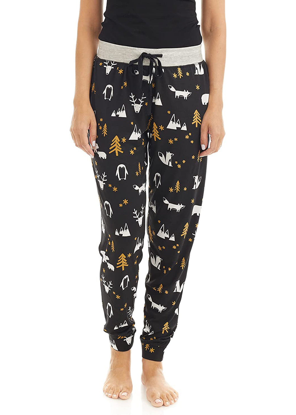 PJ joggers with soft velvety texture, stretch, elastic waistband, drawstring, and stylish ankle cuff. This pattern is little woodland creatures, like a foxm deer, penguin, and some mountains, trees. The pattern is gold and white on a black background. The waist is light grey with a black drawstring. Very cute. 