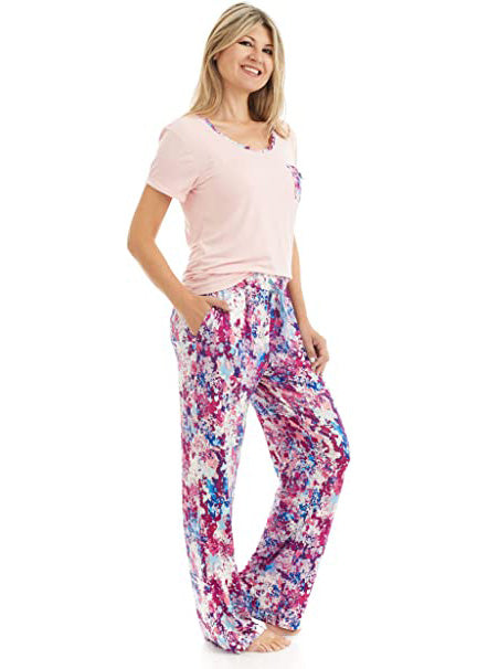 
                  
                    T Shirt and Pant Pajama set. The t-shirt is solid light pink. it has a pocket and a neck trim that matches the pattern on the pants. the pattern on the pants is a pink, white and blue flower pattern.
                  
                